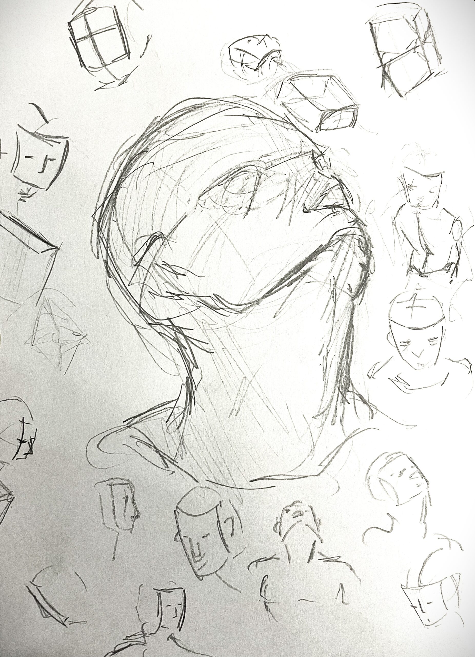 Sketches done in pencile of a mans face looking up with otehr faces and head and faces.